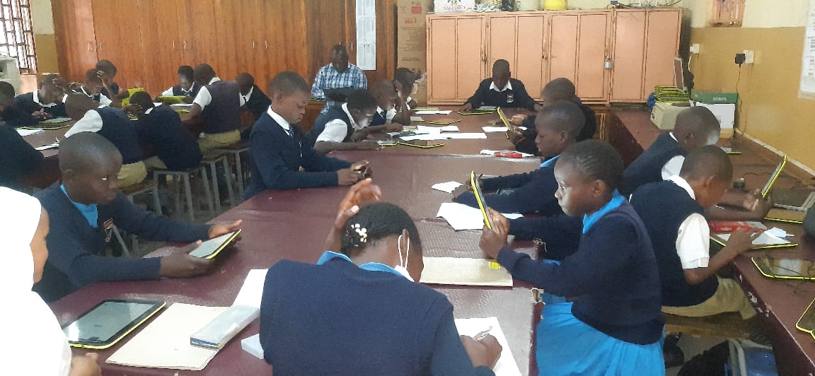 ICT Club students working with tablets and digital devices
